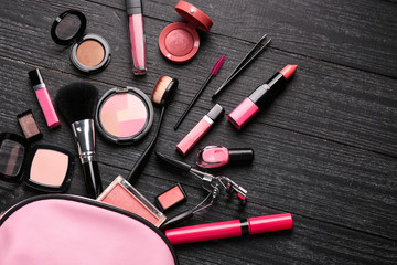 Professional makeup cosmetics with accessories on wooden background