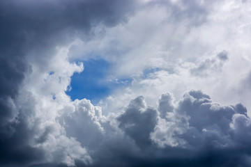 Gentle lush clouds background with gap of blue sky