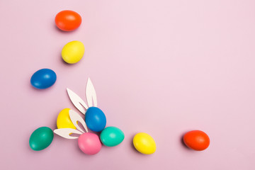 easter eggs on pink background, top view