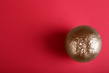 Golden citrus fruit on color background