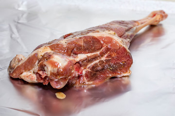 raw leg of young lamb in spices and honey with mustard. Cooking Caucasian food