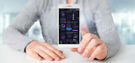 Businessman holding Smartphone with user interface data on the screen isolated on a background