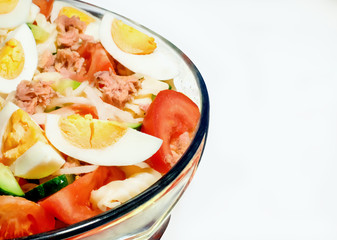 Traditional tuna salad with pasta and vegetables. White background.