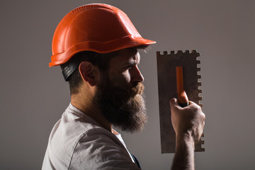 Tool, trowel, handyman, man builder. Mason tools, builder. Builders in hard hat, helmet. Bearded...