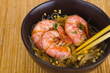 Glass noodles with sauce and shrimps, asian cuisine.