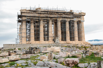 Obraz premium Athens, Greece - February 23, 2019: Western facade of the Parthenon temple on the Acropolis of Athens, Greece under reconstruction during winter 2019.