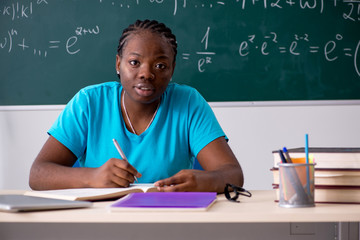 Black female student in front of chalkboard  