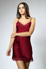 Fototapeta premium brunette model posing in red night lingerie