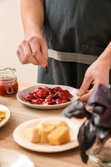Male chef preparing for serving tasty ravioli on table