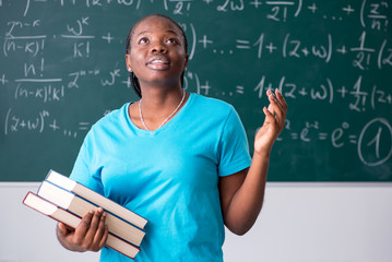 Black female student in front of chalkboard  