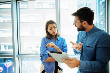 Obraz premium Young business couple with tablet in the office