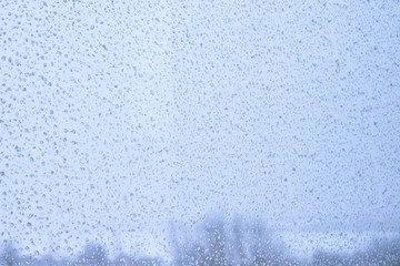 Beautiful texture of drops on the glass, tinted photo, background.