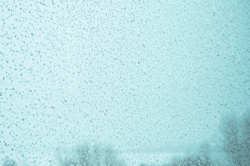 Beautiful texture of drops on the glass, tinted photo, background.