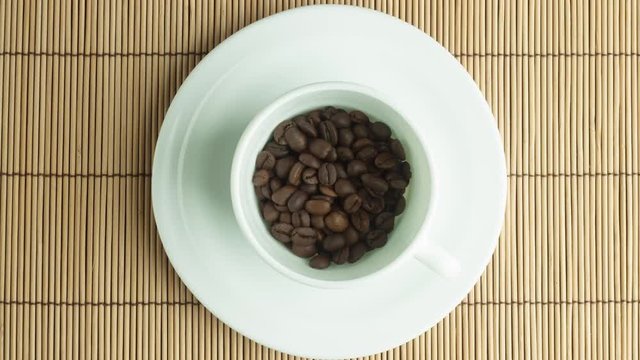 Coffee beans in a white cup stop motion