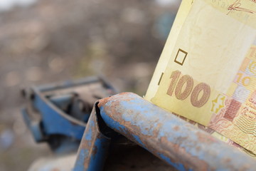 Metal barrel and Ukrainian money, the concept of the cost of gasoline, diesel, gas. Refilling the car. Banknote 100 hryvnia.