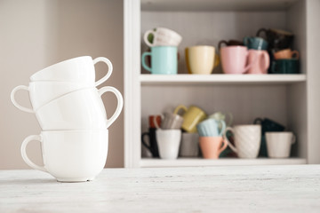 Stack of ceramic cups on white table