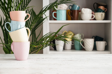 Stack of ceramic cups on white table