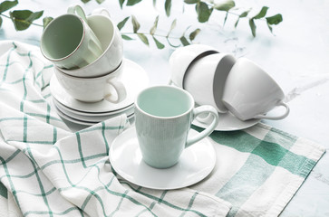 Tea cups with saucers on light table
