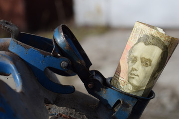 Metal barrel and Ukrainian money, the concept of the cost of gasoline, diesel, gas. Refilling the car. Banknote 100 hryvnia.