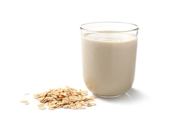Glass of tasty oat milk on white background