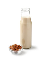 Bottle of tasty buckwheat milk on white background