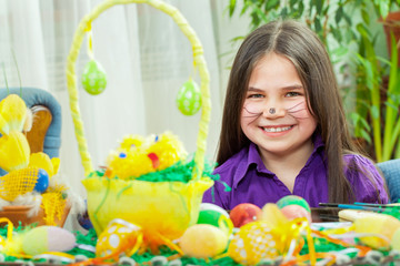 Mother and her children paint easter eggs