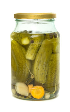 glass jar with pickled cucumbers on white background