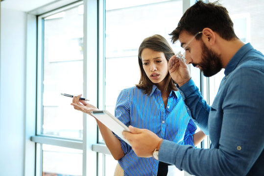 Young Business Couple With Tablet In The Office