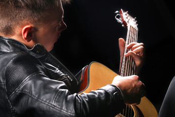 Young men playing the guitar