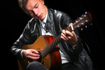 Young men playing the guitar