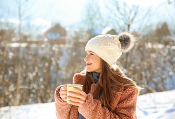 Woman with cup of hot cacao resting at resort