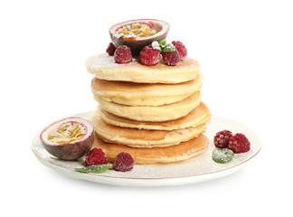 Tasty pancakes with passion fruit and berries on white background