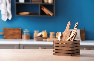 Set of wooden kitchen utensils on table