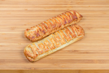 Cheese-stuffed bread sticks on a wooden cutting board