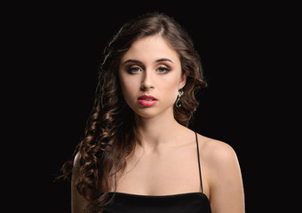 Young woman with beautiful jewelry on dark background