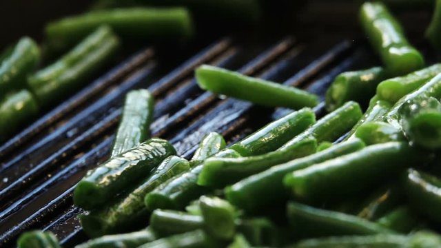The vegetable mix is fried in a frying pan. Spoon the vegetables mixed. Slow motion