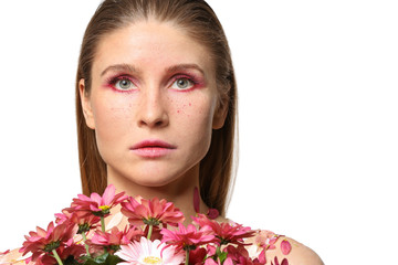 Fototapeta premium Beautiful woman with creative makeup and flowers on white background