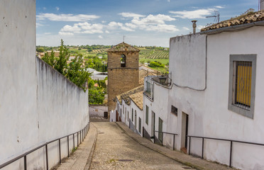 Street leading to a church tower in Ubeda, Spain