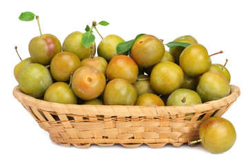 White plums in busket isolated on white background