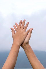 Two hands of Asian female people making hi-five gesture