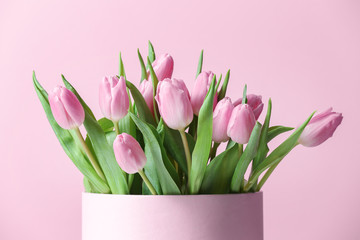 Bouquet of beautiful tulips on color background