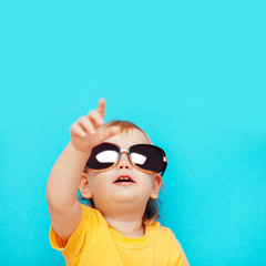 the kid in black glasses pointing up with your finger