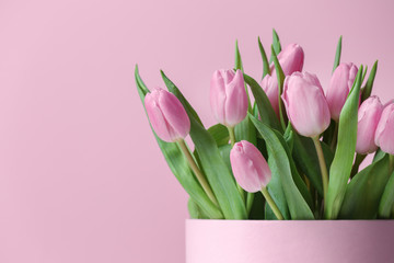 Bouquet of beautiful tulips on color background