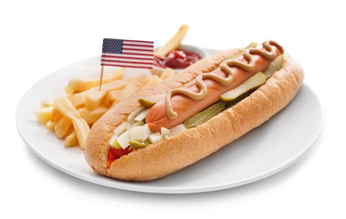 Plate with tasty hot dog, french fries and USA flag on white background