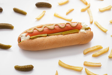 Tasty hot dog, pickled cucumbers and french fries on white background
