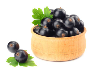 black currant in wooden bowl with green leaf isolated on white background