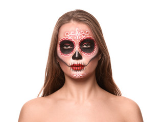 Young woman with painted skull on her face for Mexico's Day of the Dead against white background