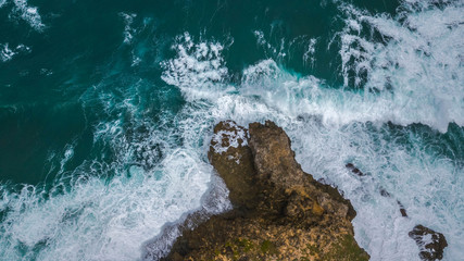 aerial view of sea waves and rocks