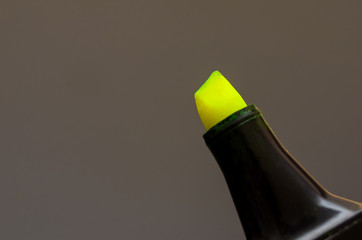 Close up of a bright yellow marker by an artist or designer on a black background. background with...