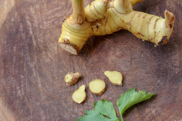 Galangal cut into thin strips with celery leaves.
